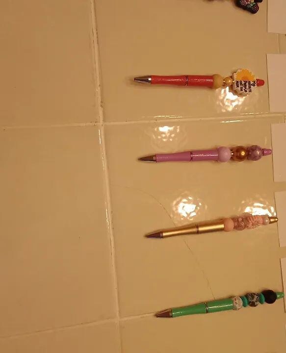 A lineup of handmade beaded pens